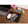 mockup of a mousepad lying on a rustic table next to a flower vase 27554