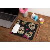 mockup of a mousepad lying on a rustic table next to a flower vase 27554