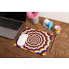 mockup of a mousepad lying on a rustic table next to a flower vase 27554