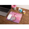 mockup of a mousepad lying on a rustic table next to a flower vase 27554