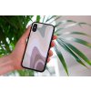 mockup of a woman holding a clear phone case in front of a houseplant 4636 el1 2022 04 12T150150.893