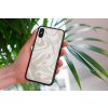 mockup of a woman holding a clear phone case in front of a houseplant 4636 el1 2022 05 04T142920.052