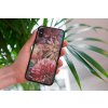 mockup of a woman holding a clear phone case in front of a houseplant 4636 el1 2022 05 23T144257.736