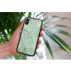 mockup of a woman holding a clear phone case in front of a houseplant 4636 el1 2022 05 04T133902.891