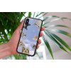 mockup of a woman holding a clear phone case in front of a houseplant 4636 el1 2022 05 04T142216.958