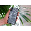 mockup of a woman holding a clear phone case in front of a houseplant 4636 el1 2022 04 26T134805.149