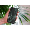 mockup of a woman holding a clear phone case in front of a houseplant 4636 el1 2022 04 26T134448.942