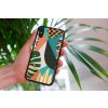 mockup of a woman holding a clear phone case in front of a houseplant 4636 el1 2022 05 23T145035.912