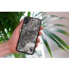 mockup of a woman holding a clear phone case in front of a houseplant 4636 el1 2022 05 04T144038.114