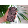 mockup of a woman holding a clear phone case in front of a houseplant 4636 el1 2022 04 26T133324.887