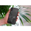 mockup of a woman holding a clear phone case in front of a houseplant 4636 el1 2022 05 04T141841.730