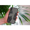 mockup of a woman holding a clear phone case in front of a houseplant 4636 el1 (3)