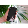 mockup of a woman holding a clear phone case in front of a houseplant 4636 el1 (8)