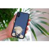 mockup of a woman holding a clear phone case in front of a houseplant 4636 el1 (1)
