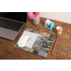 mockup of a mousepad lying on a rustic table next to a flower vase 27554