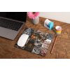 mockup of a mousepad lying on a rustic table next to a flower vase 27554