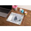 mockup of a mousepad lying on a rustic table next to a flower vase 27554