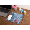 mockup of a mousepad lying on a rustic table next to a flower vase 27554 (1)