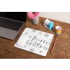 mockup of a mousepad lying on a rustic table next to a flower vase 27554 (1)