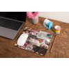 mockup of a mousepad lying on a rustic table next to a flower vase 27554