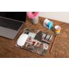 mockup of a mousepad lying on a rustic table next to a flower vase 27554