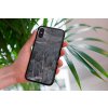 mockup of a woman holding a clear phone case in front of a houseplant 4636 el1 (1)