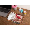 mockup of a mousepad lying on a rustic table next to a flower vase 27554 (2)