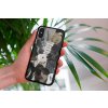 mockup of a woman holding a clear phone case in front of a houseplant 4636 el1