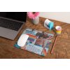 mockup of a mousepad lying on a rustic table next to a flower vase 27554