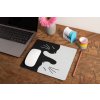 mockup of a mousepad lying on a rustic table next to a flower vase 27554