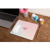 mockup of a mousepad lying on a rustic table next to a flower vase 27554