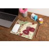 mockup of a mousepad lying on a rustic table next to a flower vase 27554 (1)