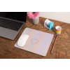 mockup of a mousepad lying on a rustic table next to a flower vase 27554