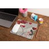 mockup of a mousepad lying on a rustic table next to a flower vase 27554