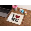 mockup of a mousepad lying on a rustic table next to a flower vase 27554