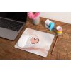 mockup of a mousepad lying on a rustic table next to a flower vase 27554