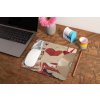 mockup of a mousepad lying on a rustic table next to a flower vase 27554
