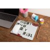 mockup of a mousepad lying on a rustic table next to a flower vase 27554