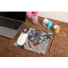 mockup of a mousepad lying on a rustic table next to a flower vase 27554