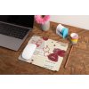 mockup of a mousepad lying on a rustic table next to a flower vase 27554
