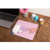 mockup of a mousepad lying on a rustic table next to a flower vase 27554