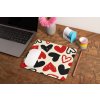 mockup of a mousepad lying on a rustic table next to a flower vase 27554