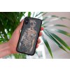 mockup of a woman holding a clear phone case in front of a houseplant 4636 el1 (16)