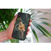 mockup of a woman holding a clear phone case in front of a houseplant 4636 el1 2022 05 04T135109.644