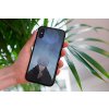 mockup of a woman holding a clear phone case in front of a houseplant 4636 el1 (25)