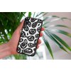 mockup of a woman holding a clear phone case in front of a houseplant 4636 el1 2022 04 27T132827.593