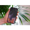 mockup of a woman holding a clear phone case in front of a houseplant 4636 el1 2022 04 26T134134.589