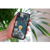 mockup of a woman holding a clear phone case in front of a houseplant 4636 el1 (2)