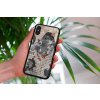 mockup of a woman holding a clear phone case in front of a houseplant 4636 el1