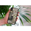mockup of a woman holding a clear phone case in front of a houseplant 4636 el1 2023 03 16T114517.890